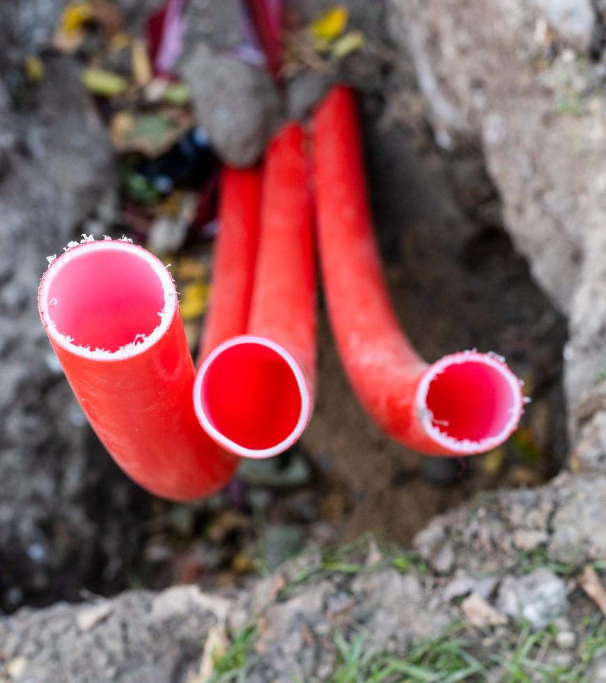 red-plastic-conduit-pipes-in-trench-closeup-2026-01-09-11-20-01-utc-scaled.jpg